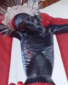 San Juan Patrón crucifix with a silver spiked crown and red drapery