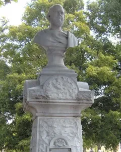 Beriah Magoffin Monument with a bust of a bearded man on a pedestal in a cemetery.