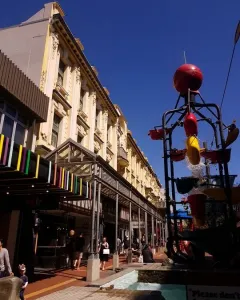 The Bucket Fountain with red and yellow buckets tipping water into a shallow pool in Wellington.