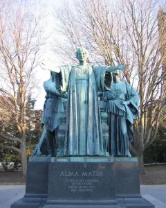 Alma Mater statue with a bronze female figure and two robed figures on a stone pedestal