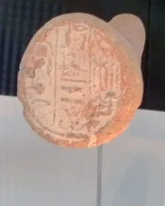 Merimose funerary cone with impressed hieroglyphs on a reddish-brown clay surface.