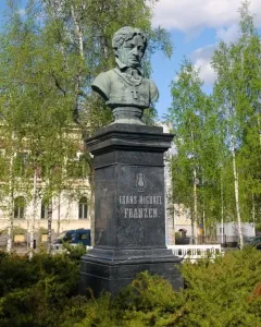 Bust of Frans Michael Franzén on a tall stone pedestal with carved lettering and a lyre emblem.