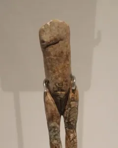 Immodest Venus mammoth ivory figurine with a slender female form on a dark stand
