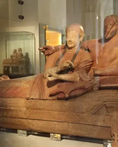 Sarcophagus of the Spouses terracotta sculpture of a reclining married couple in a museum display case.