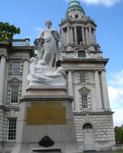 Titanic Memorial statue in Belfast, with a female figure holding a wreath above figures on a granite pedestal.