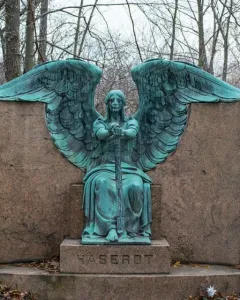 Haserot Angel bronze sculpture with outstretched wings and inverted torch atop a granite monument