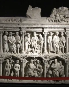 The Sarcophagus of Junius Bassus with two carved relief registers showing draped figures in architectural niches.