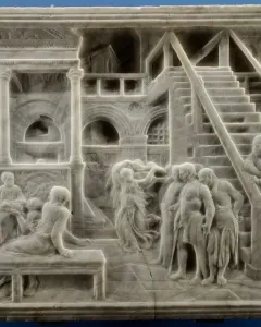 The Feast of Herod marble relief with figures gathered around a banquet table, a dancing woman in the center, and arched colonnades behind them.