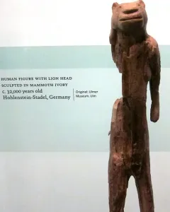 Lion-man sculpture with a lion-like head and human body standing upright.