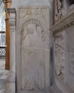 Tomb of Giovanni Crivelli stone relief with a carved effigy beneath a scalloped arch and winged figures above.