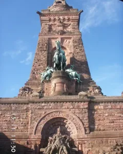 Kyffhäuser Monument with a large equestrian statue above a carved stone arch and seated bearded figure.