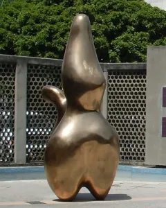 Cloud Shepherd bronze abstract sculpture with smooth organic contours on a tiled outdoor plaza.
