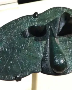 Bronze Liver of Piacenza with engraved lines, inscriptions, and uneven raised sections.