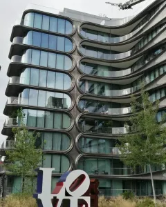 The LOVE sculpture in Chelsea, New York, with a blue L and white tilted LO and VE letters accented in red and brown.
