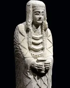 Lady of Cerro de los Santos statue holding a small vessel at chest level