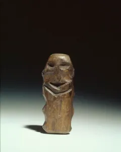 Mannetje van Willemstad wooden idol with a dark weathered surface and carved facial features.