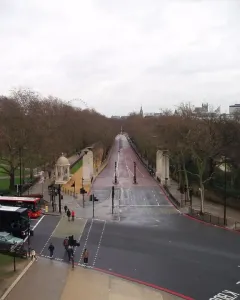 Commonwealth Memorial Gates beside a tree-lined avenue at Hyde Park Corner, London.