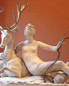 The Fountain of Diana, a marble sculpture of a nude woman with a bow embracing a stag, with two dogs on the basin below.