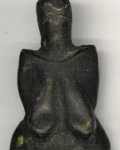 Venus of Dolní Věstonice figurine with rounded head, prominent breasts, and a full abdomen.