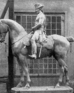 The Equestrian Monument of Frederick the Great shown as a large equestrian statue on a simple base in front of a building with many windows.