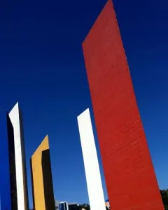 Torres de Satélite with five brightly colored geometric towers against a blue sky.