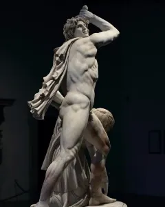 Ludovisi Gaul sculpture with a muscular warrior raising a sword over his head beside a fallen figure.