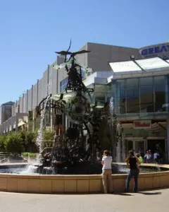 Hornsby Water Clock fountain sculpture with gears, pipes, and cascading water in a plaza