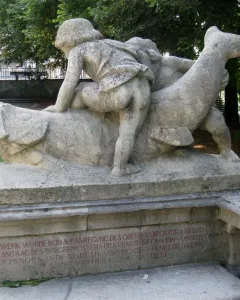 Rhine Water Fountain sculpture with two figures seated on a fish-like creature above a shallow pool.