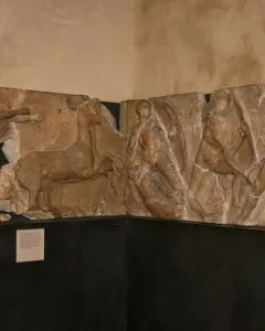 Bassae Frieze marble relief panels showing draped figures, a deer-like animal, and a centaur in a battle scene.