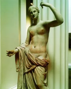 Townley Venus marble statue with one arm raised and the other extended, draped below the waist.