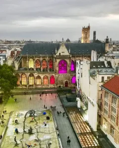 Stravinsky Fountain with colorful abstract sculptures in a rectangular basin in a city square.