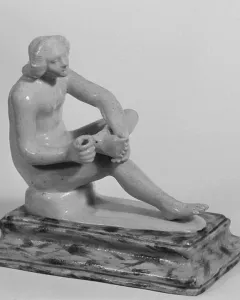 Boy with Thorn statue of a nude youth seated and looking down at his raised foot
