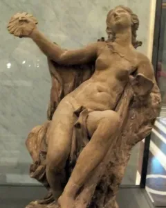 Truth Unveiled by Time sculpture showing a reclining nude female figure holding a disc aloft, with a rough unfinished figure behind her.