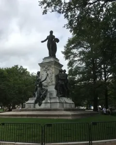 The Marquis de Lafayette statue, a large bronze monument with figures on a stone pedestal in a fenced park.