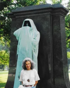 Eternal Silence sculpture, a hooded bronze figure standing before a dark stone slab.