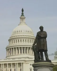James A. Garfield Monument with a bronze statue of James A. Garfield in front of the U.S. Capitol dome and columns