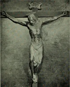 Santa Croce Crucifix showing a wooden Christ figure on the cross with bowed head, halo, loincloth, and INRI plaque above.