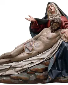 Pietà sculpture in polychrome wood showing the Virgin Mary supporting the lifeless body of Christ.