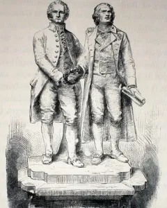 Goethe and Schiller Monument showing two standing male figures on a tiered stone pedestal, one holding a wreath and the other a rolled document.