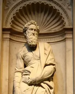 Marble statue of Saint Paul standing in an ornate niche with flowing robes and a bearded face.