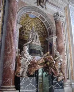 Tomb of Pope Alexander VII with a praying figure, white marble allegorical statues, and a dramatic draped canopy above a doorway.