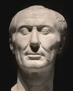 Weathered marble bust of the Tusculum portrait showing a stern-faced man with receding wavy hair and deep facial wrinkles.