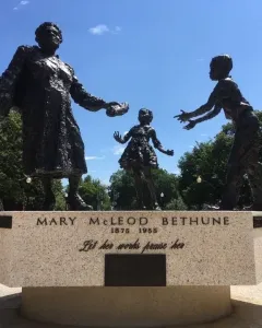 Mary McLeod Bethune Memorial bronze statue of Mary McLeod Bethune with two children reaching toward her.