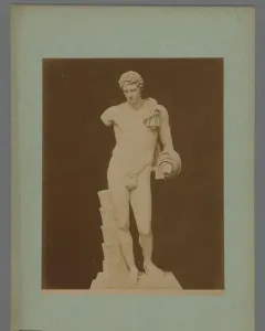 Hermes Belvedere, a white marble nude male statue with short curly hair, a draped cloth over one shoulder, and a missing left forearm.