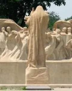 Lorado Taft\'s Fountain of Time sculpture with a central robed figure overseeing a long procession of human figures.