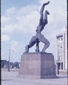 The Destroyed City sculpture by Ossip Zadkine in an open plaza, showing a dark figure with raised arms and a jagged void in its torso.