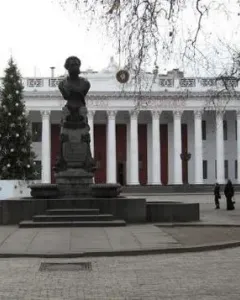 Pushkin bust on a tall ornate pedestal in a paved plaza