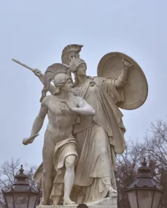 Athena Protects the Young Hero stone sculpture showing a helmeted goddess with shield and spear behind a young hero.