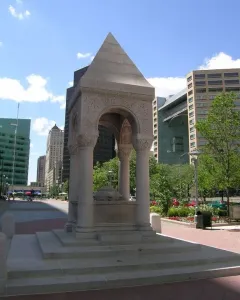 Bagley Memorial Fountain with a pyramidal roof, carved arches, and a lion-head relief in Detroit\'s Cadillac Square.