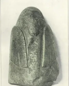 Tuxtla Statuette with an elongated carved head, protruding mouth, and incised decorative patterns